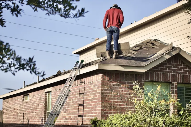Professional roofer working on a residential roof in Francisville